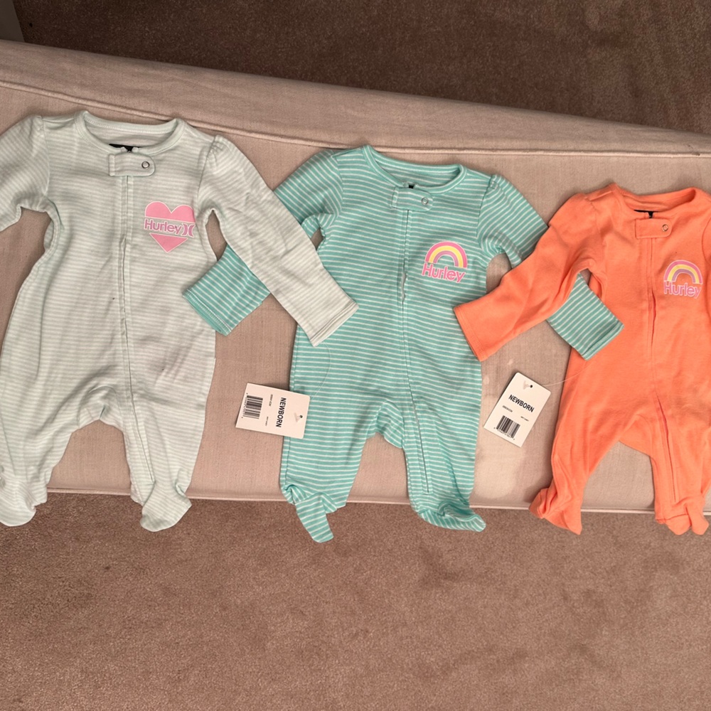 Set of three long sleeve, Hurley brand new newborn, zip-up one piece